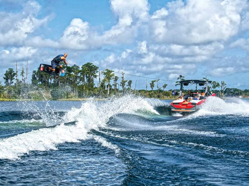 BTG0522-QST-Learn-Wakeboard Wakeboarder launching over wake
