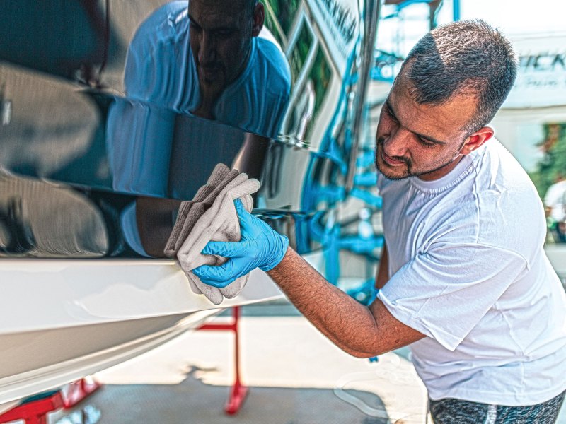 BTG525-LAB-Cleaners Applying coating to boat
