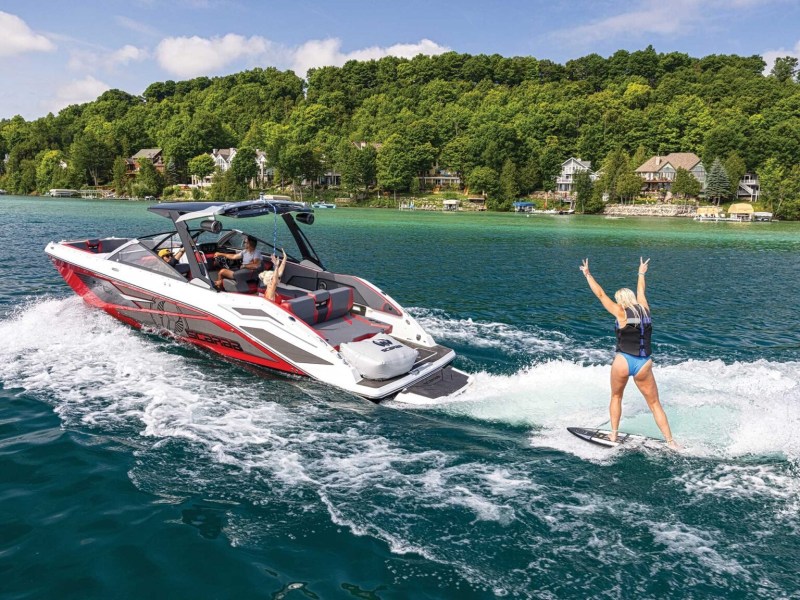 Woman wake surfing behind a Scarab 285 LX Wake